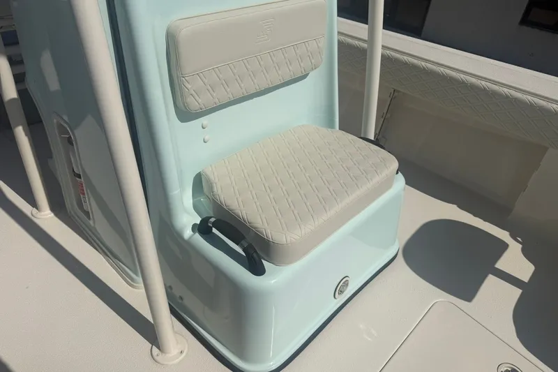 Slide: The Image of 2027 Carolina Skiff 26 Ultra Elite boat seat with light blue and white upholstery. - 20