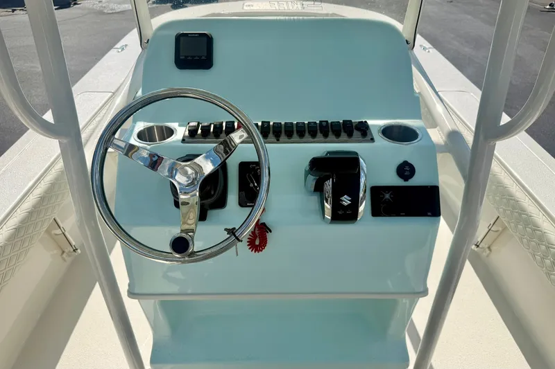 Slide: The Image of 2027 Carolina Skiff 26 Ultra Elite boat console with steering wheel and controls. - 3