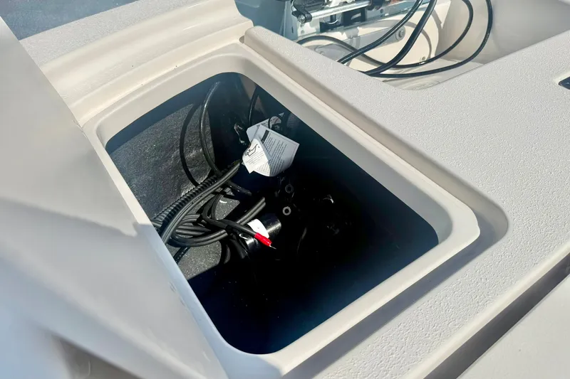 Slide: The Image of Open storage compartment on 2027 Carolina Skiff 26 Ultra Elite boat, showing wiring and cables. - 38