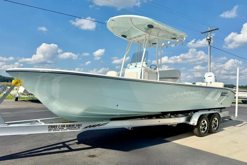 Slide: The Image of 2027 Carolina Skiff 26 Ultra Elite boat on trailer under blue sky. - 5