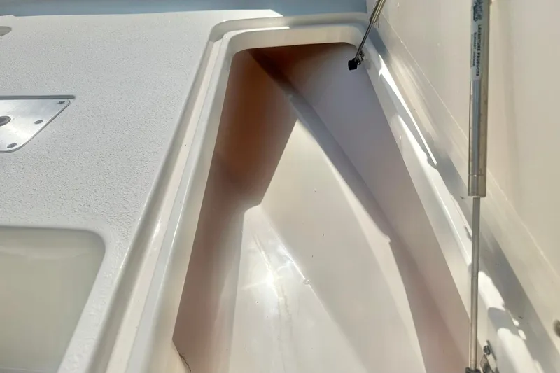 Slide: The Image of Storage compartment of a 2027 Carolina Skiff 26 Ultra Elite boat, featuring a clean interior. - 18