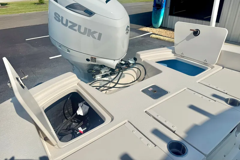 Slide: The Image of 2027 Carolina Skiff 26 Ultra Elite boat with Suzuki outboard motor and storage compartments. - 37