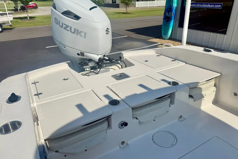 Slide: The Image of 2027 Carolina Skiff 26 Ultra Elite boat with Suzuki outboard motor, docked outdoors. - 40
