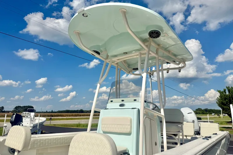 Slide: The Image of 2027 Carolina Skiff 26 Ultra Elite boat under a clear blue sky with clouds. - 46