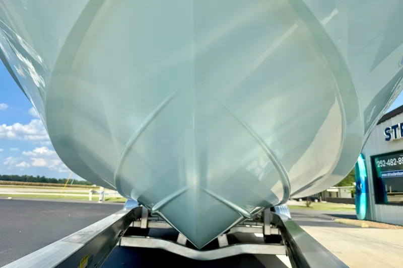 Slide: The Image of 2027 Carolina Skiff 26 Ultra Elite boat hull on trailer, outdoor dealership setting. - 9