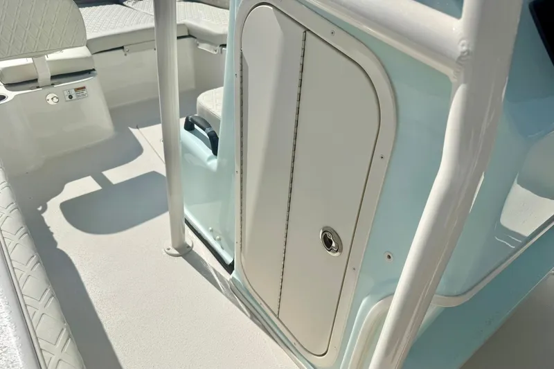 Slide: The Image of 2027 Carolina Skiff 26 Ultra Elite boat interior with seating and storage compartment. - 28