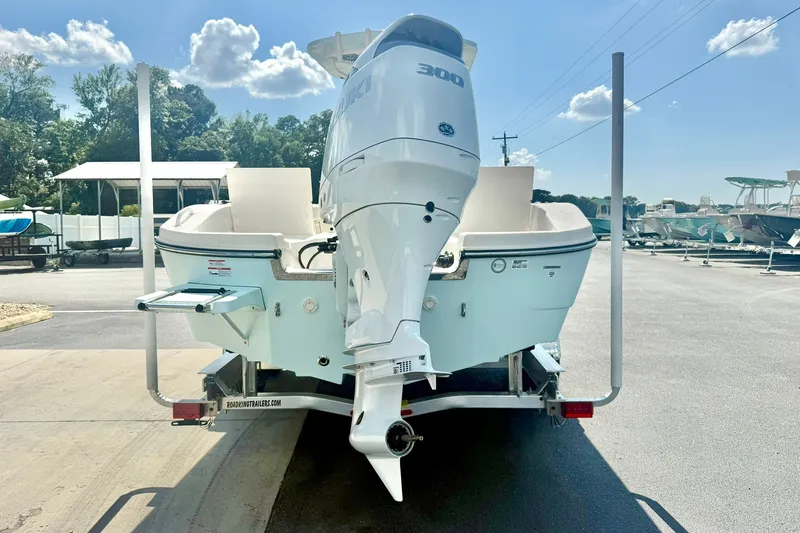 Slide: The Image of 2027 Carolina Skiff 26 Ultra Elite boat with powerful outboard motor on trailer. - 2
