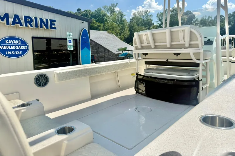 Slide: The Image of 2027 Carolina Skiff 26 Ultra Elite boat interior with seating and storage, near marine shop. - 43