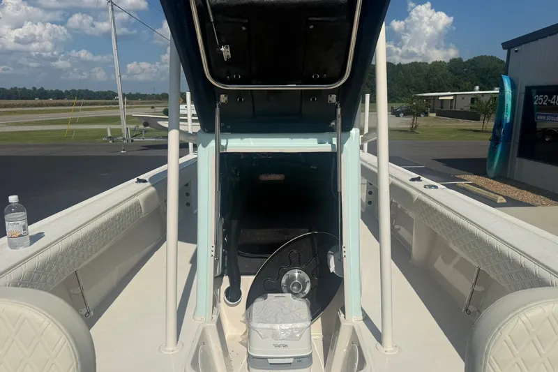 Slide: The Image of 2027 Carolina Skiff 26 Ultra Elite boat interior with steering wheel and seating. - 21