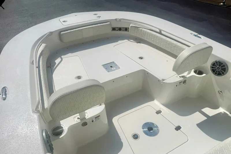 Slide: The Image of 2027 Carolina Skiff 26 Ultra Elite boat interior with cushioned seating and cup holders. - 12