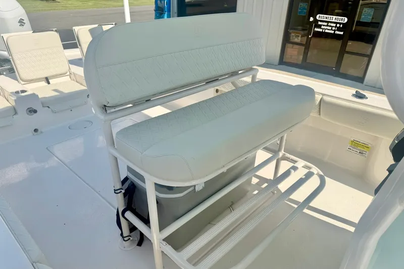 Slide: The Image of 2027 Carolina Skiff 26 Ultra Elite boat interior with cushioned seating and storage. - 24