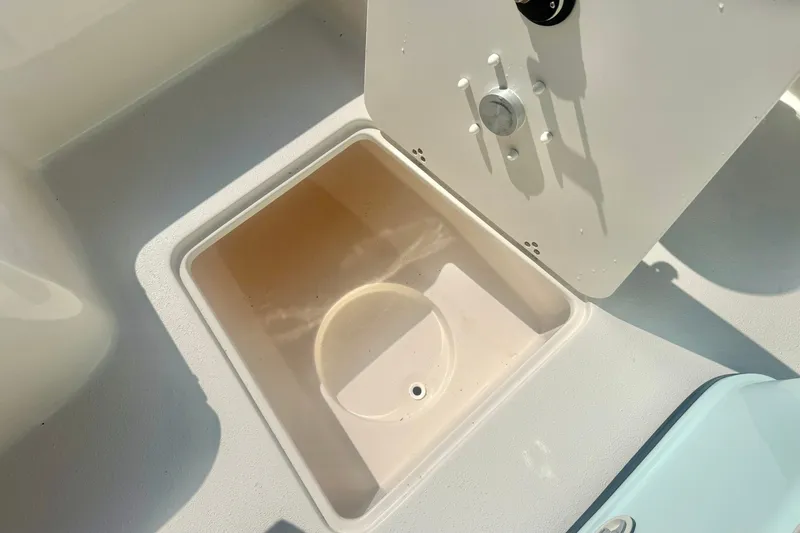 Slide: The Image of Storage compartment on 2027 Carolina Skiff 26 Ultra Elite boat, open lid view. - 19