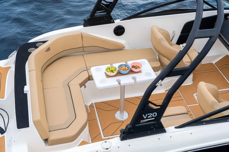 Slide: The Image of Luxurious 2026 Bayliner V20 boat interior with seating, table, and snacks on the water. - 7