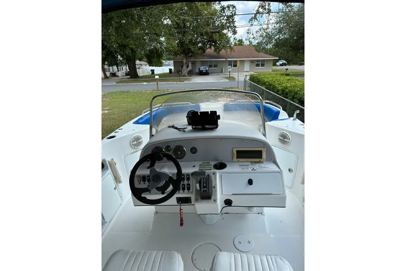 Slide: The Image of 2012 Hurricane Center Console 231 OB boat interior with steering wheel and control panel. - 3