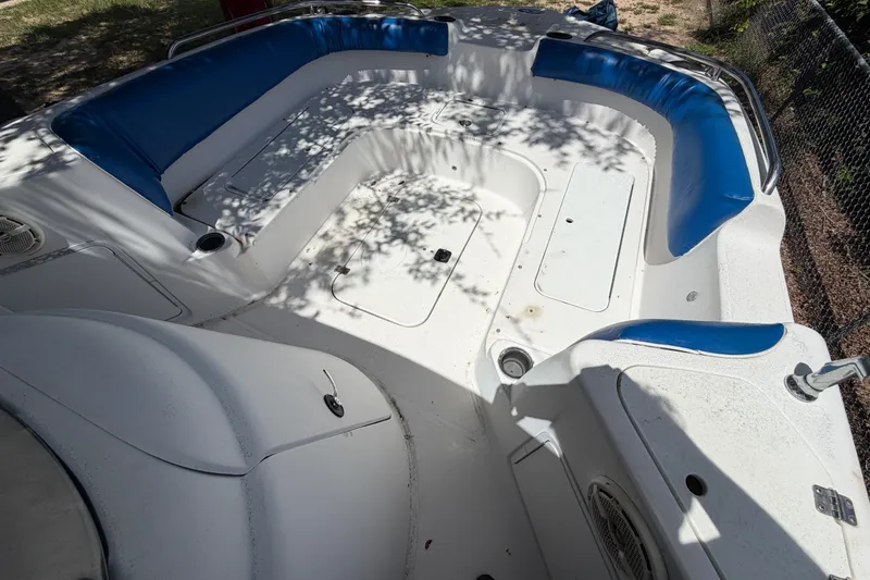 Slide: The Image of 2012 Hurricane Center Console 231 OB boat interior with blue seating and storage compartments. - 15