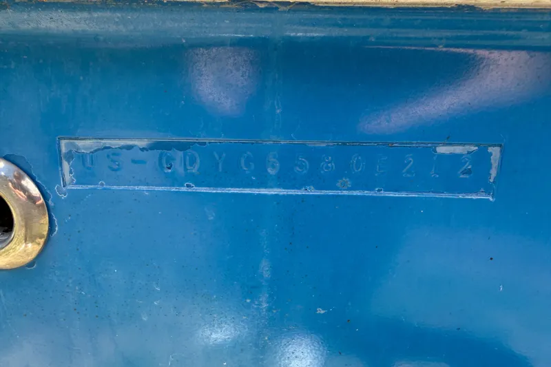 Slide: The Image of 2012 Hurricane Center Console 231 OB boat hull identification number on blue surface. - 18