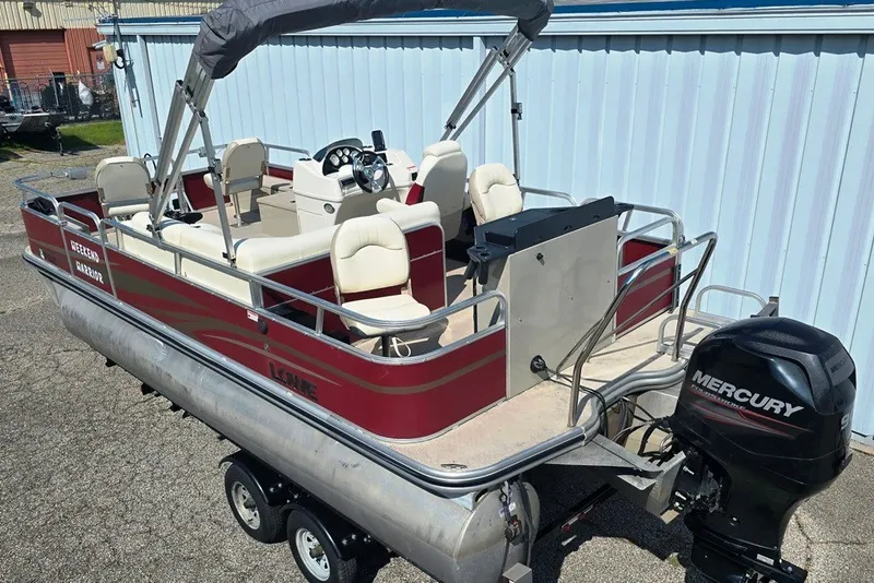 Slide: The Image of 2013 Lowe SF 214 Sport Fish pontoon boat with Mercury outboard motor on trailer. - 1