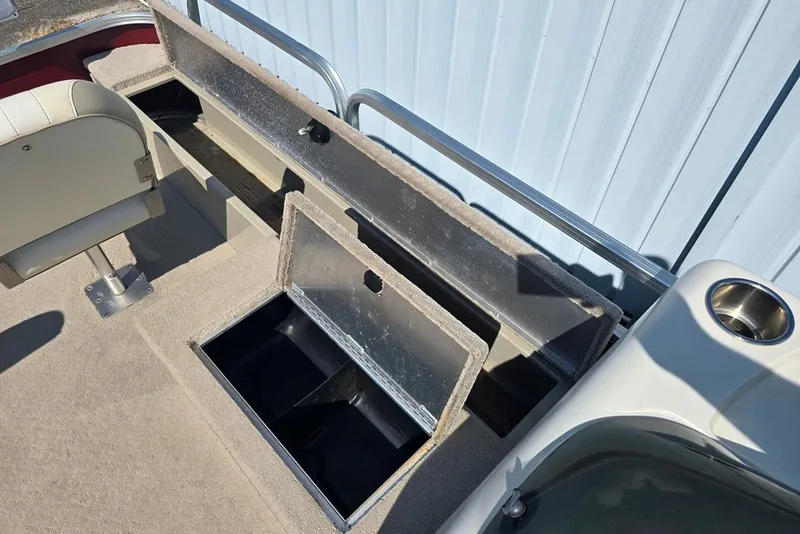 Slide: The Image of 2013 Lowe SF 214 Sport Fish boat interior with storage compartments and seating. - 5