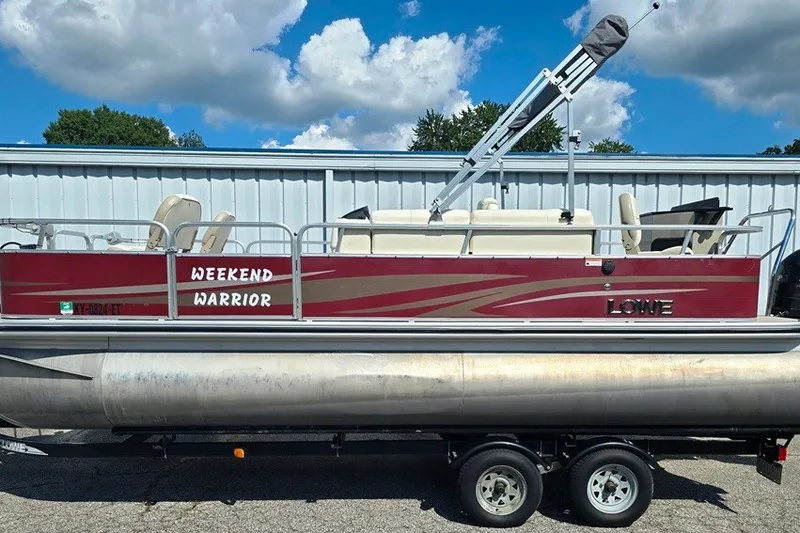 Slide: The Image of 2013 Lowe SF 214 Sport Fish pontoon boat on trailer, labeled "Weekend Warrior." - 18
