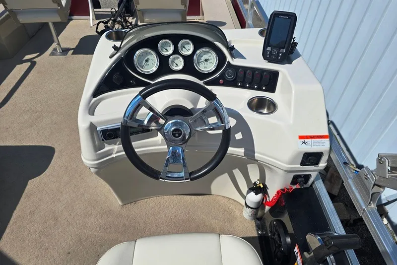 Slide: The Image of Steering console of 2013 Lowe SF 214 Sport Fish boat with gauges and controls. - 13