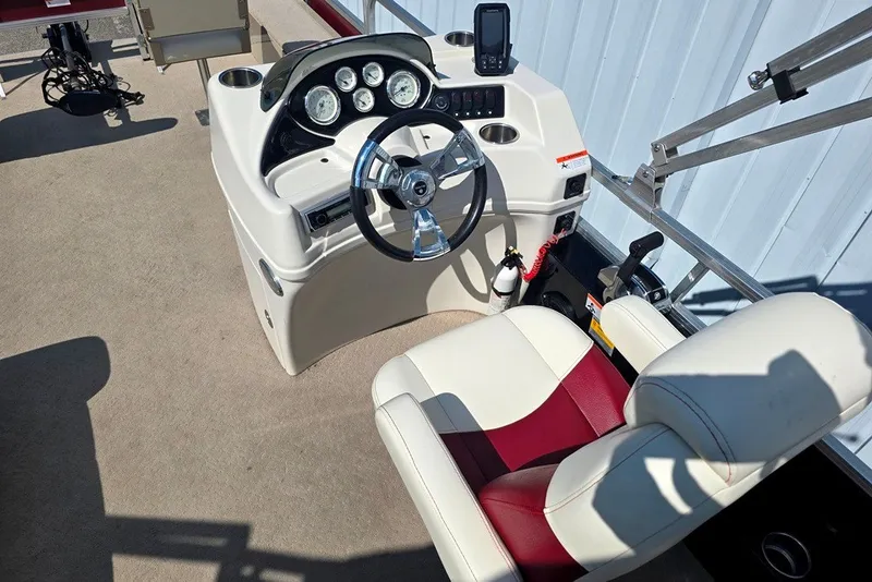 Slide: The Image of 2013 Lowe SF 214 Sport Fish boat helm with steering wheel and control panel. - 3