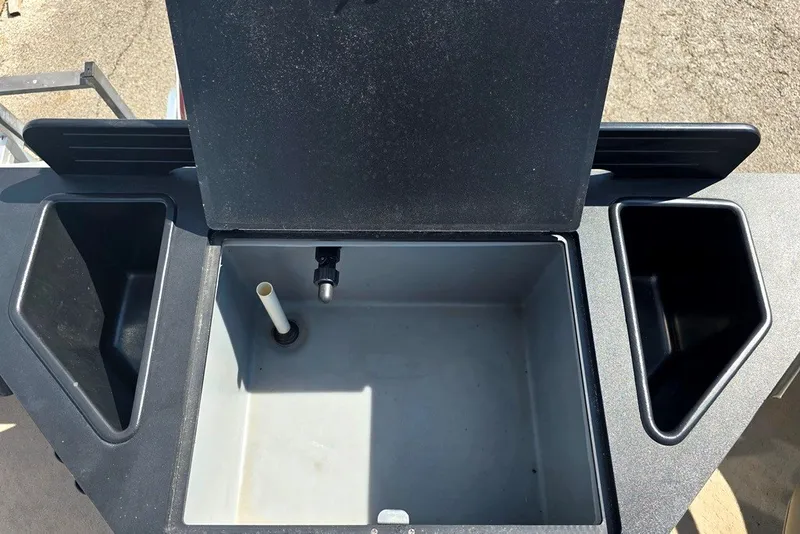 Slide: The Image of Livewell compartment on a 2013 Lowe SF 214 Sport Fish boat, featuring storage and drainage. - 8