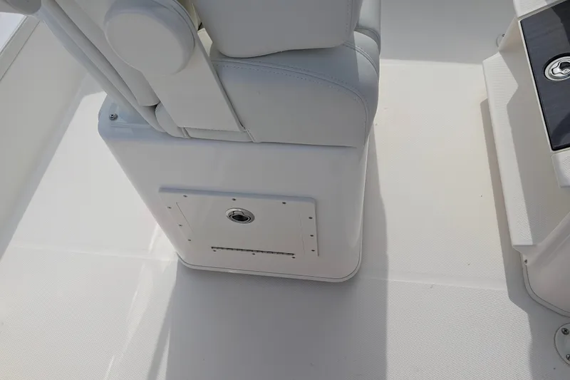Slide: The Image of The image shows a white boat seat with storage underneath on a Pathfinder 2400 Hybrid. - 34