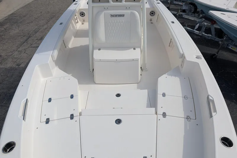 Slide: The Image of The image shows the deck of a 2027 Pathfinder 2400 Hybrid boat with white seating and storage. - 31
