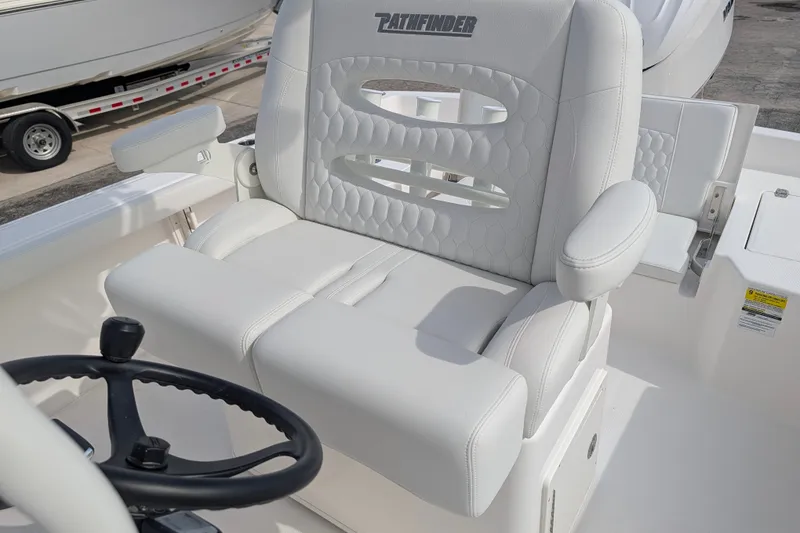 Slide: The Image of A luxurious, padded captain's chair with armrests and a steering wheel in a modern boat. - 36