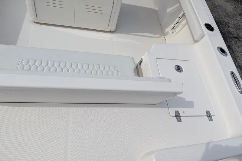 Slide: The Image of The image shows the white deck of a 2027 Pathfinder 2400 Hybrid boat with a bench seat and storage compartment. - 14