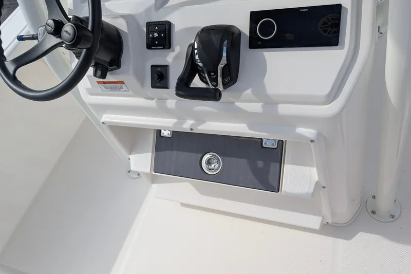 Slide: The Image of The image shows the helm of a Pathfinder 2400 Hybrid boat with modern controls. - 33