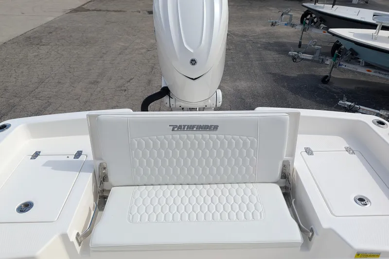Slide: The Image of The image shows the stern of a Pathfinder 2400 Hybrid boat with a white cushioned seat. - 35