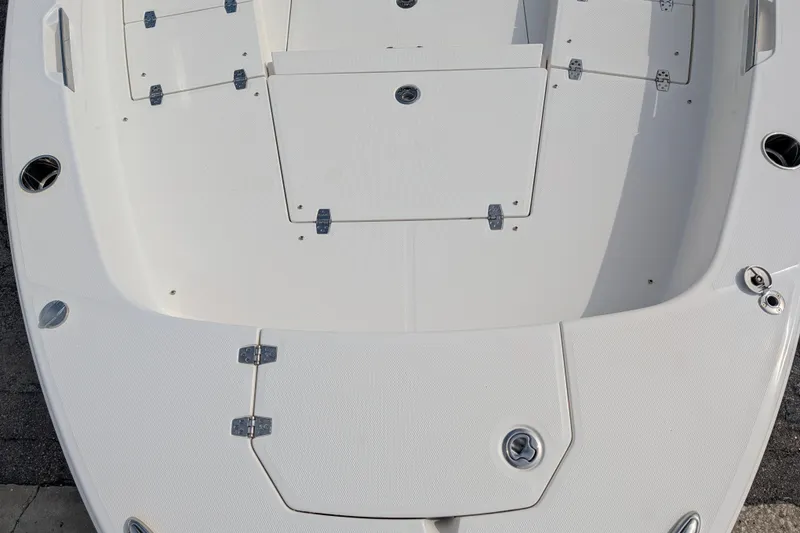 Slide: The Image of The image shows the deck of a 2027 Pathfinder 2400 Hybrid boat with multiple storage compartments. - 29