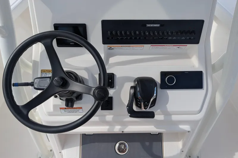 Slide: The Image of The image shows the helm of a Pathfinder 2400 Hybrid boat with a steering wheel and controls. - 19