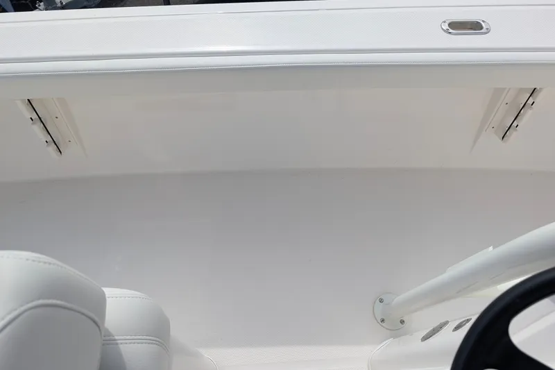 Slide: The Image of The image shows the interior of a 2027 Pathfinder 2400 Hybrid with white upholstery and a helm. - 18