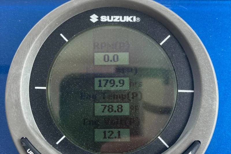 Slide: The Image of Suzuki digital gauge on 2000 Baha Cruisers 272 Sportfish boat displaying various metrics. - 16