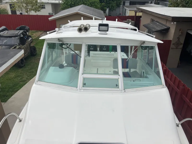 Slide: The Image of 2000 Baha Cruisers 272 Sportfish boat, front view, docked in residential area. - 5