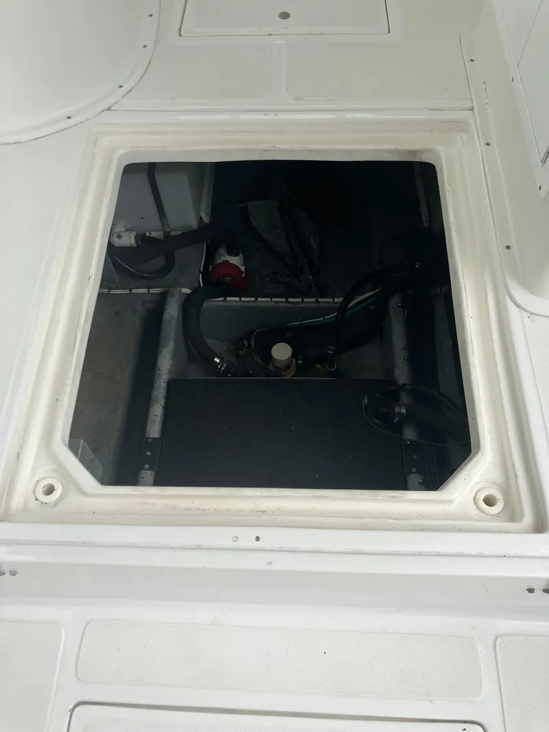 Slide: The Image of Open hatch of a 2000 Baha Cruisers 272 Sportfish boat showing internal components. - 29