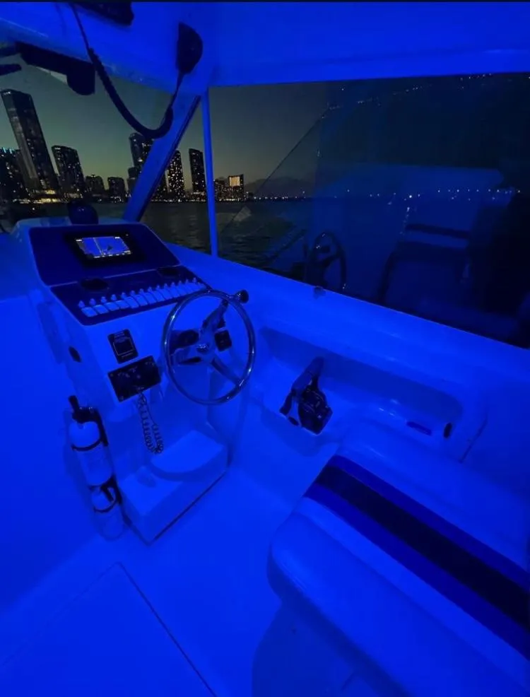 Slide: The Image of Interior of 2000 Baha Cruisers 272 Sportfish boat at night with city skyline. - 44