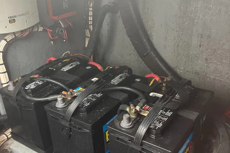 Slide: The Image of Baha Cruisers 272 Sportfish 2000 boat battery compartment with multiple batteries. - 21