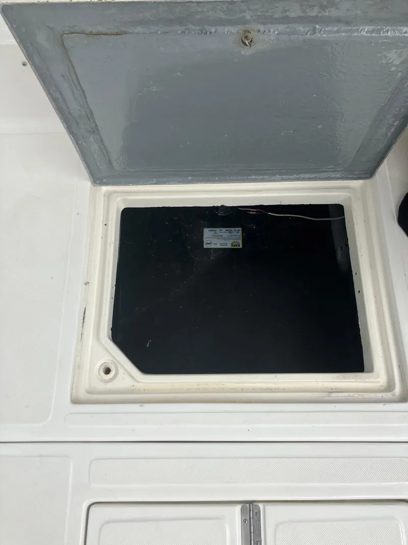 Slide: The Image of Open storage compartment on a 2000 Baha Cruisers 272 Sportfish boat. - 37