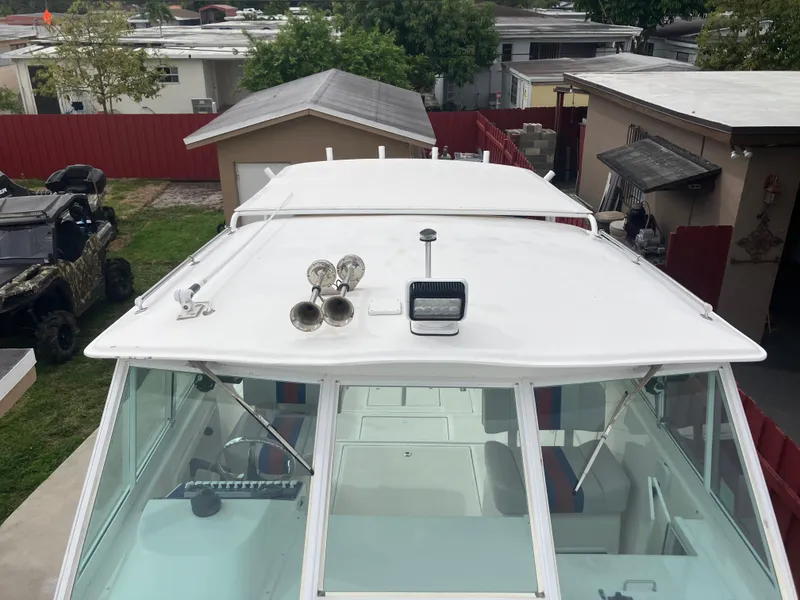 Slide: The Image of 2000 Baha Cruisers 272 Sportfish boat with a white cabin and roof accessories. - 7