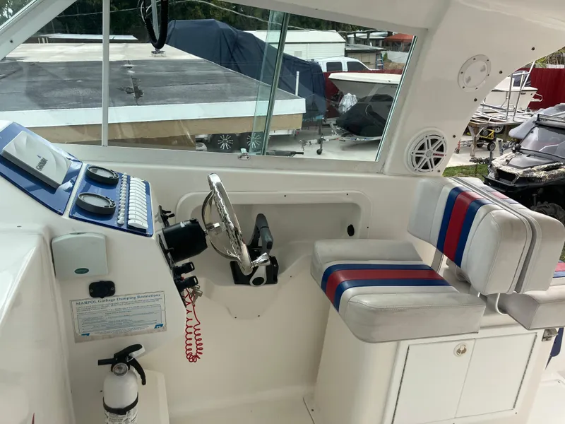 Slide: The Image of 2000 Baha Cruisers 272 Sportfish boat cockpit with steering wheel and seating. - 20