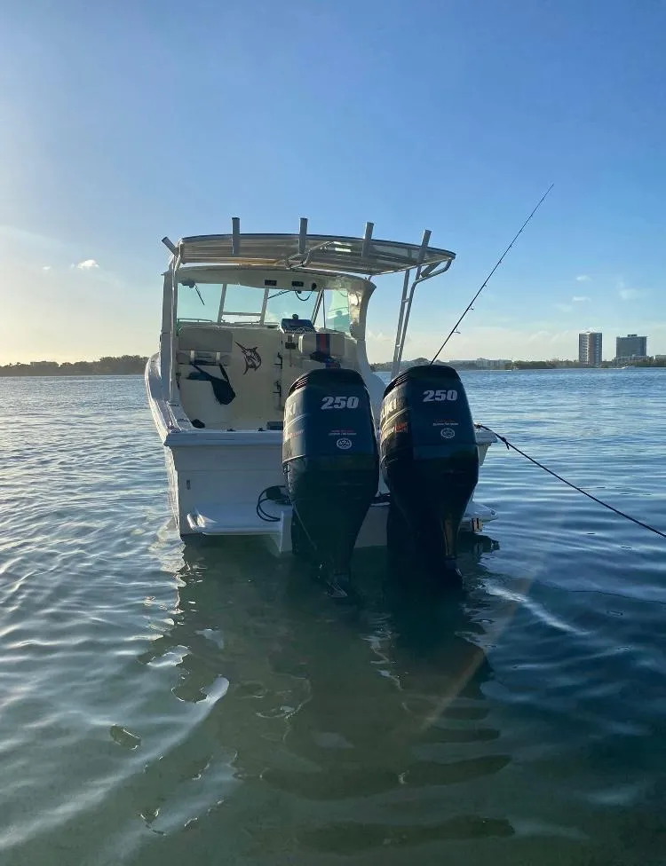 Slide: The Image of 2000 Baha Cruisers 272 Sportfish boat with twin 250 HP outboard motors on water. - 45