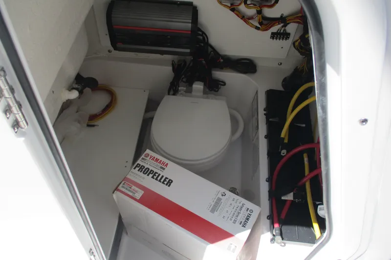 Slide: The Image of 2027 Sportsman Open 232 Center Console storage with Yamaha propeller box and marine equipment. - 14