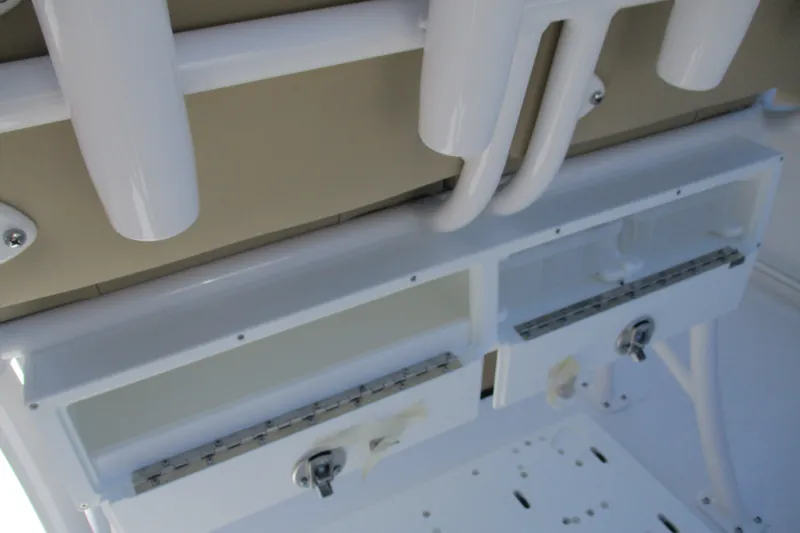 Slide: The Image of 2027 Sportsman Open 232 Center Console boat storage compartments and rod holders. - 13