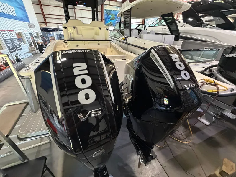 Slide: The Image of Two Mercury 200 HP V6 outboard engines on a Scout 260 LXF boat in a warehouse. - 22