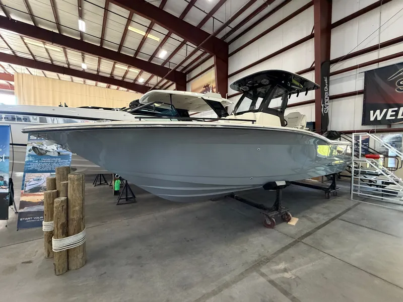 The Image of A 2027 Scout 260 LXF boat is displayed indoors on a trailer. - 0