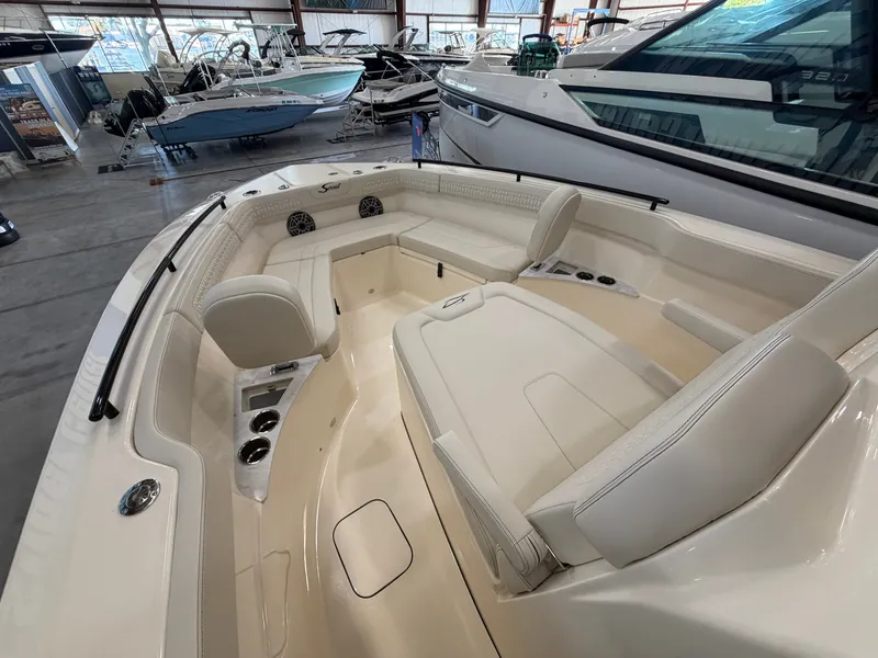 Slide: The Image of The image shows the cockpit of a 2027 Scout 260 LXF boat with sleek seating. - 13