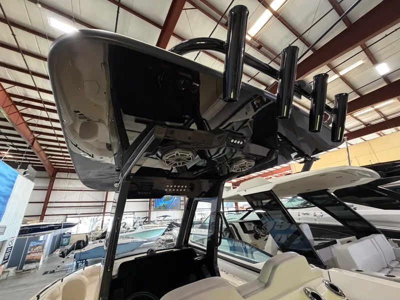 Slide: The Image of The image shows the interior of a 2027 Scout 260 LXF boat with speakers and rod holders. - 14